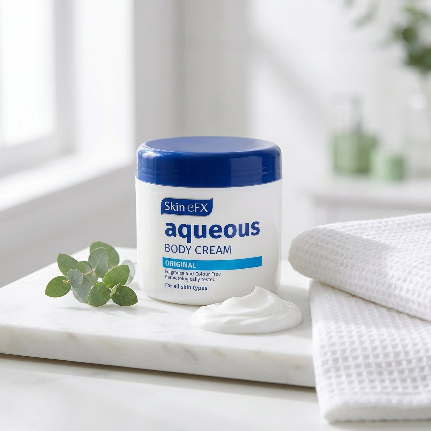 Skin eFX Aqueous Body Cream on a marble shelf with eucalyptus